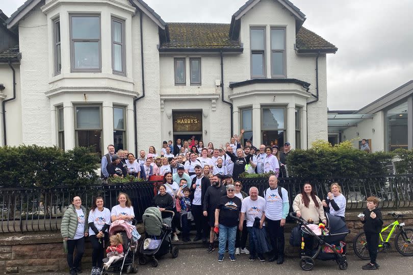 Some of the walkers pictured outside Angels in Uddingston -Credit:Lisini Group