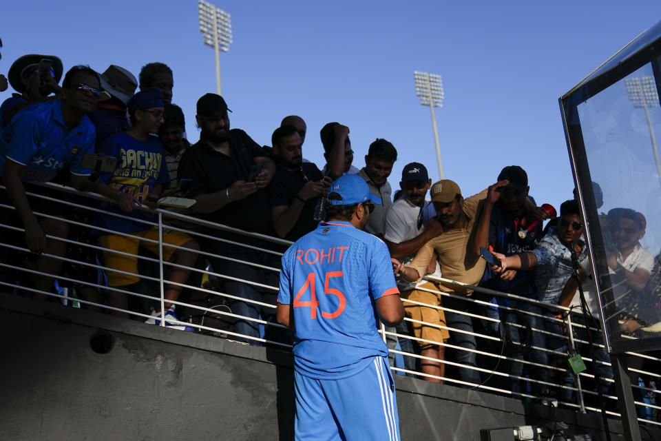 India's Rohit Sharma signs autograph after the third ODI cricket match between India and West Indies at the Brian Lara Stadium in Tarouba, Trinidad and Tobago, Wednesday, Aug. 2, 2023. (AP Photo/Ramon Espinosa)