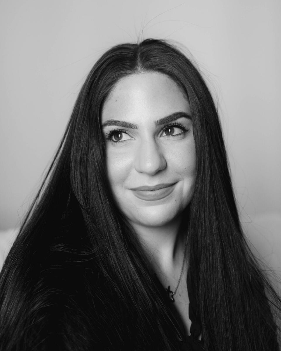 A close up photo of a woman with long black hair.