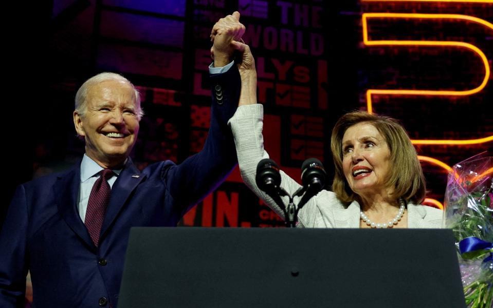 Mr Biden and Ms Pelosi hold hands at the EMILYs List Gala where the former Speaker of the House was honoured in May 2023