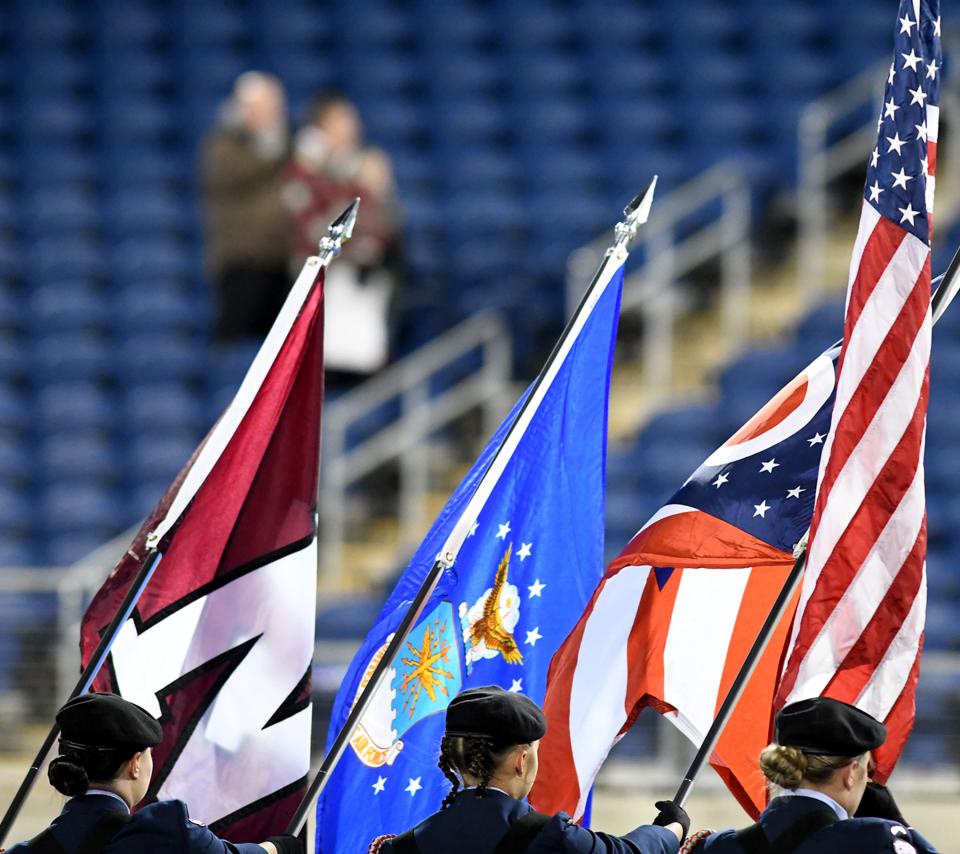 Newark High School Air Force Junior ROTC members take the field before the start of the OHSAA State Football Division IV Championship game at Tom Benson Hall of Fame Stadium in Canton.