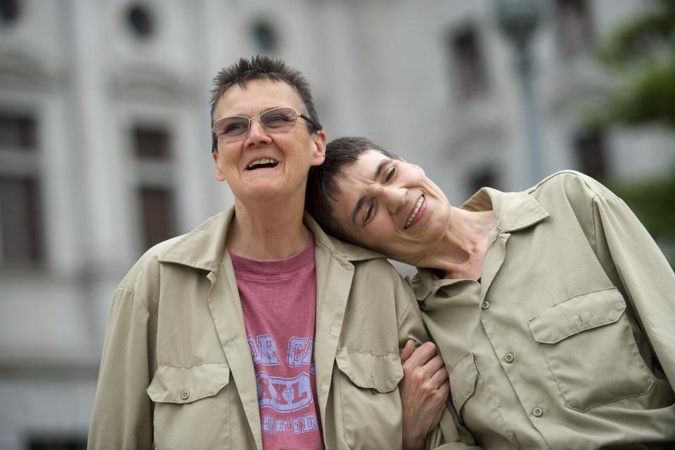 Original plaintiffs against the state of Pennsylvania (L-R) Marla Cattermole and Julia Lobur join gay rights supporters on the state capitol building steps after a ruling struck down a ban on same-sex marriage in Harrisburg, Pennsylvania, May 20, 2014. (REUTERS/Mark Makela)