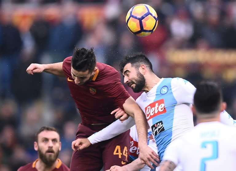 Roma's defender Kostas Manolas (L) fights for the ball with Napoli's defender Raul Albiol during the Italian Serie A football match March 4, 2017