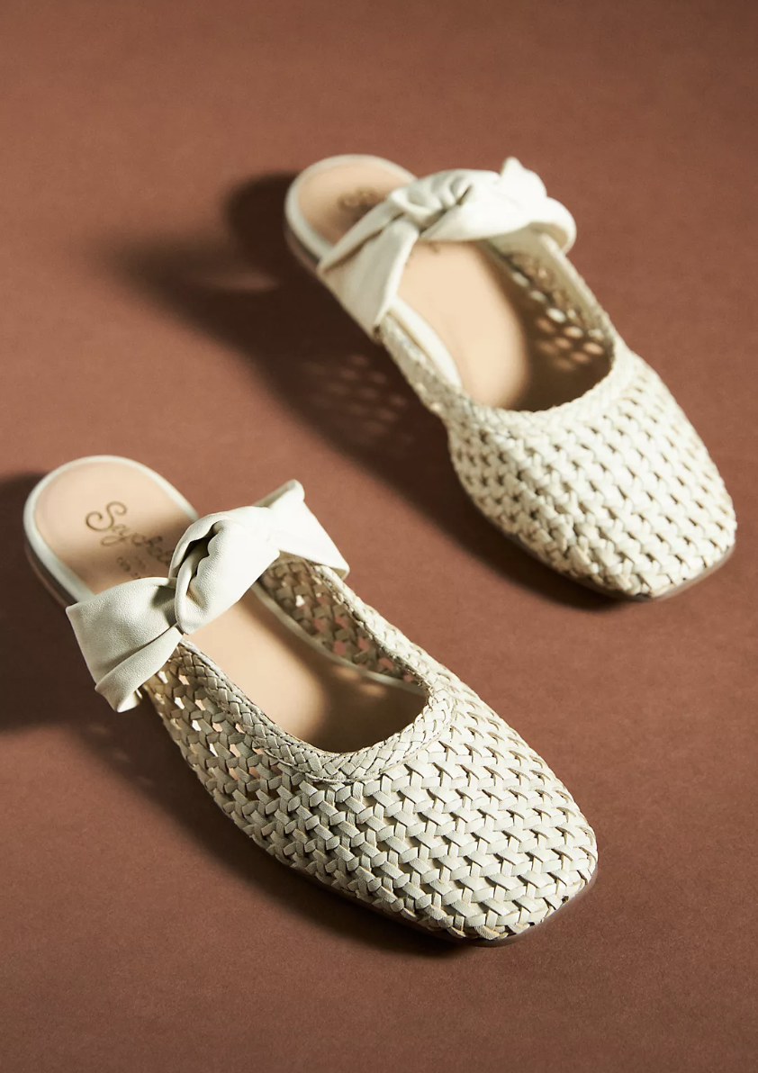 Seychelles Art Deco Flats in braided leather and white bow on brown background (photo via Anthropologie)