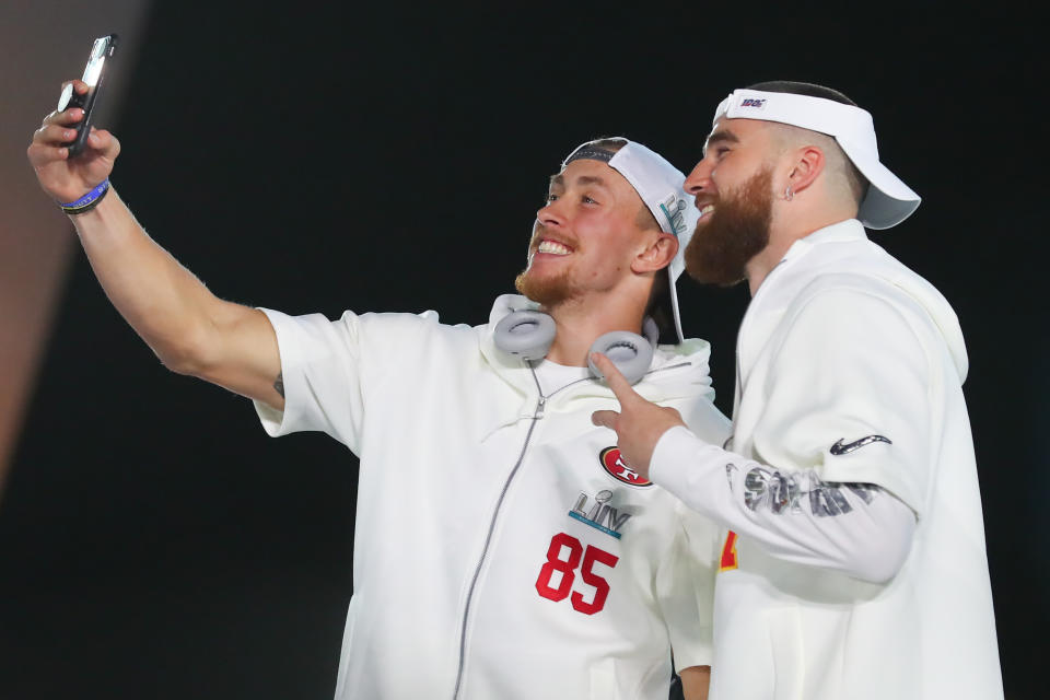 San Francisco 49ers tight end George Kittle (85) and Kansas City Chiefs tight end Travis Kelce (87) take a selfie during Super Bowl LIV Opening Night. (Photo by Rich Graessle/PPI/Icon Sportswire via Getty Images)