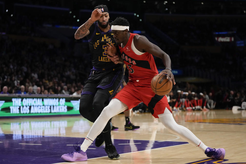 Los Angeles Lakers forward Anthony Davis (3) defends against Toronto Raptors forward Pascal Siakam (43) during the first half of an NBA basketball game in Los Angeles, Tuesday, Jan. 9, 2024. (AP Photo/Ashley Landis)