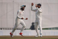 Cricket - India v England - Third Test cricket match - Punjab Cricket Association Stadium, Mohali, India - 29/11/16. India's Virat Kohli and Ravindra Jadeja (L) celebrate the dismissal of England's Jos Buttler. REUTERS/Adnan Abidi