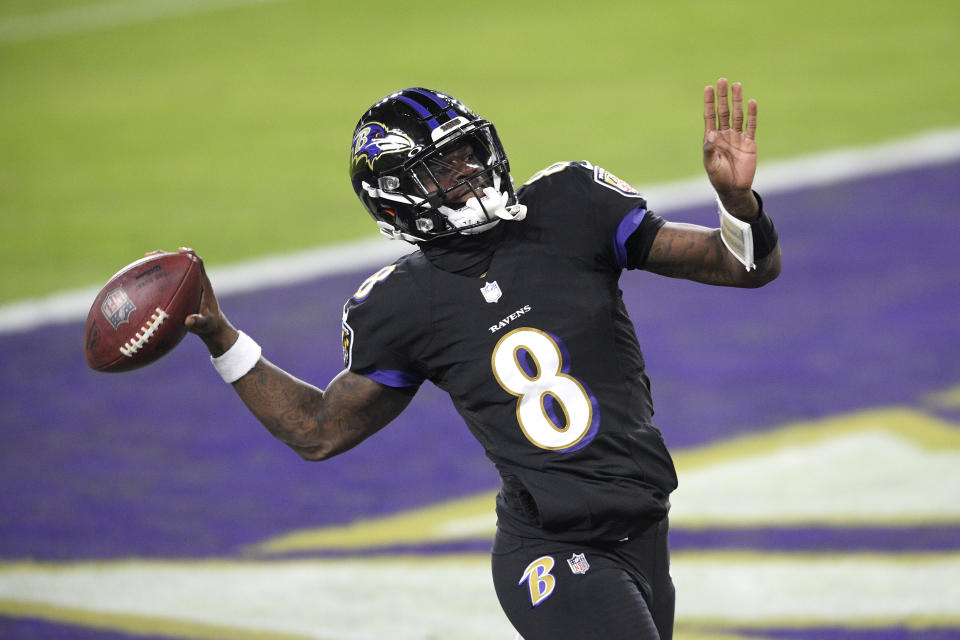 Baltimore Ravens quarterback Lamar Jackson pretends to throw the ball into the stands after scoring a touchdown on a keeper against the Dallas Cowboys during the first half of an NFL football game, Tuesday, Dec. 8, 2020, in Baltimore. (AP Photo/Nick Wass)