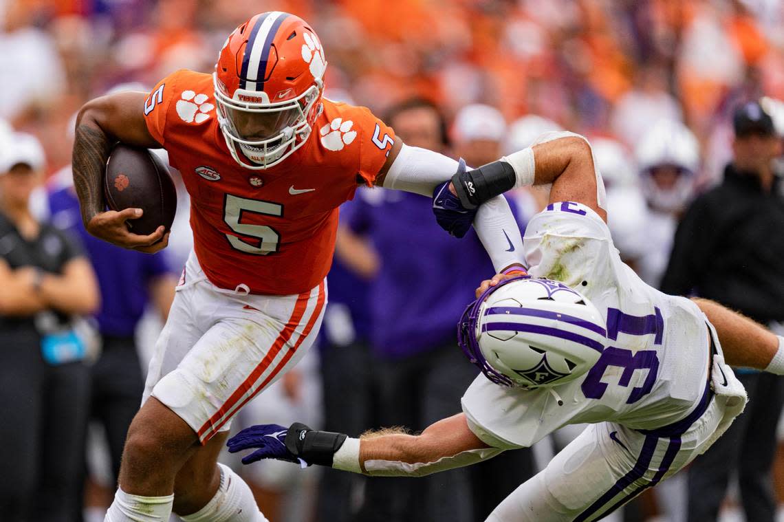Clemson Tigers quarterback DJ Uiagalelei (5) stiff arms Furman Paladins linebacker Bryce McCormick (31) in the second quarter during an NCAA college football game in Clemson, S.C., Saturday, Sept. 10, 2022. (AP Photo/Jacob Kupferman)
