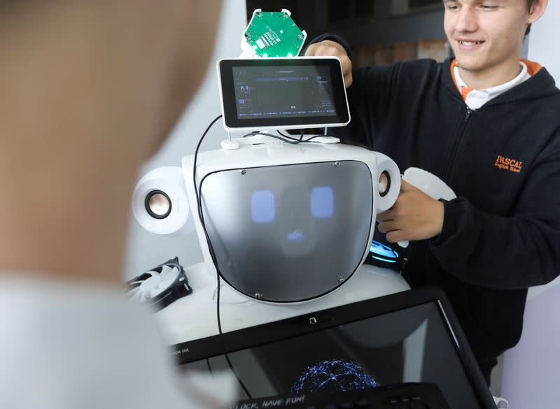 High school students Konstantinos Timinis and Vladimir Baranov work on "Alnstein", a robot powered by ChatGPT, in Pascal school in Nicosia,