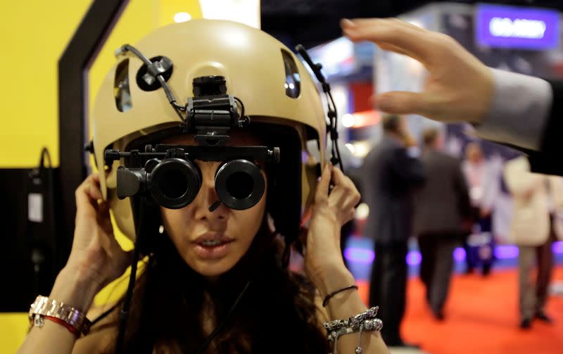 FILE PHOTO: A visitor tries on an ANVIS/HUD at the Elbit Systems booth at the Singapore Airshow in Singapore