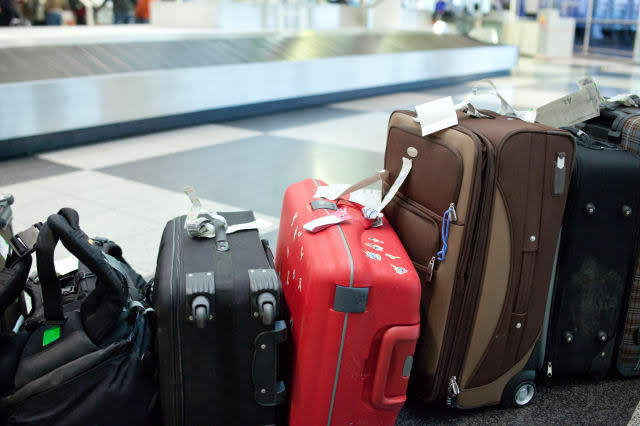 luggage lined up at the baggage claime in an airport