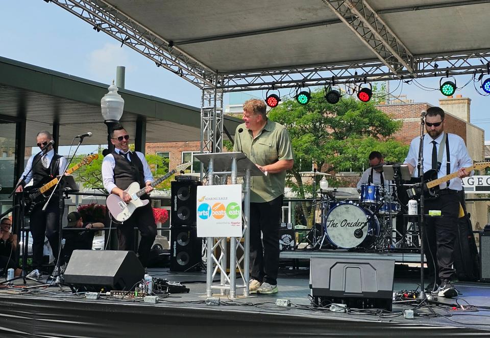 Arts, Beats & Eats director Jon Witz (center) is joined by Oakland County band the Oneders at a media event in Royal Oak on July 25, 2023.