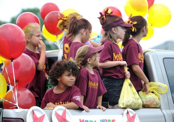 Youth league players ride in parades at the Cy Young Festival parade.