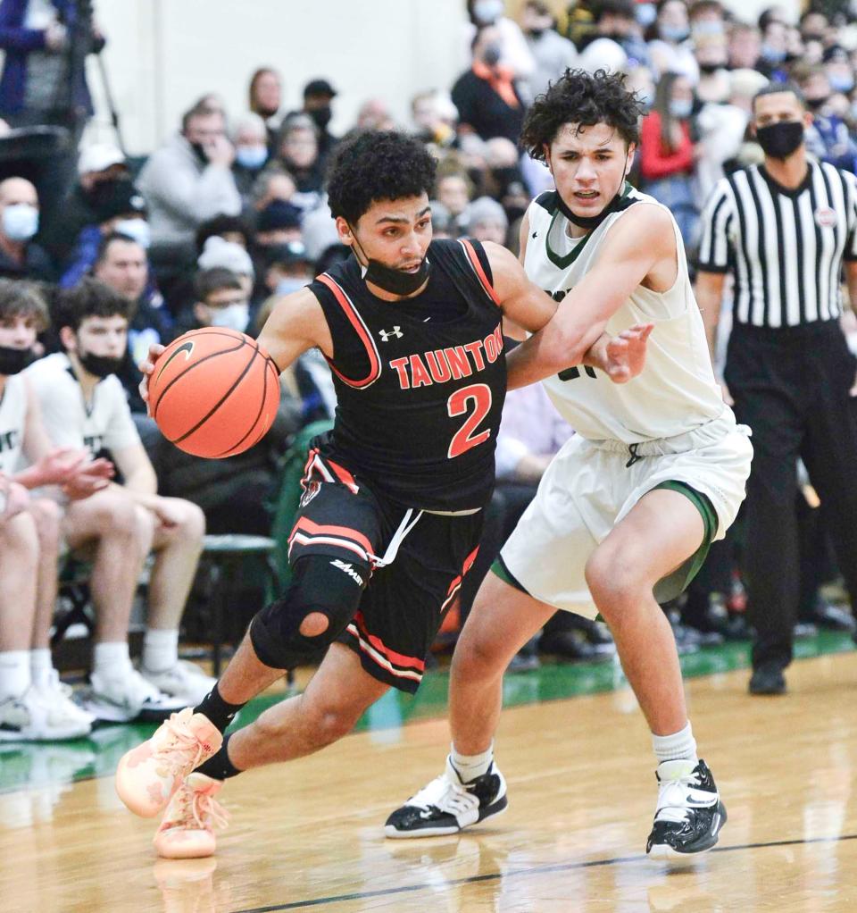 Taunton's Tristan Herry dribbles around Mansfield's Caden Colby during Friday night's game.