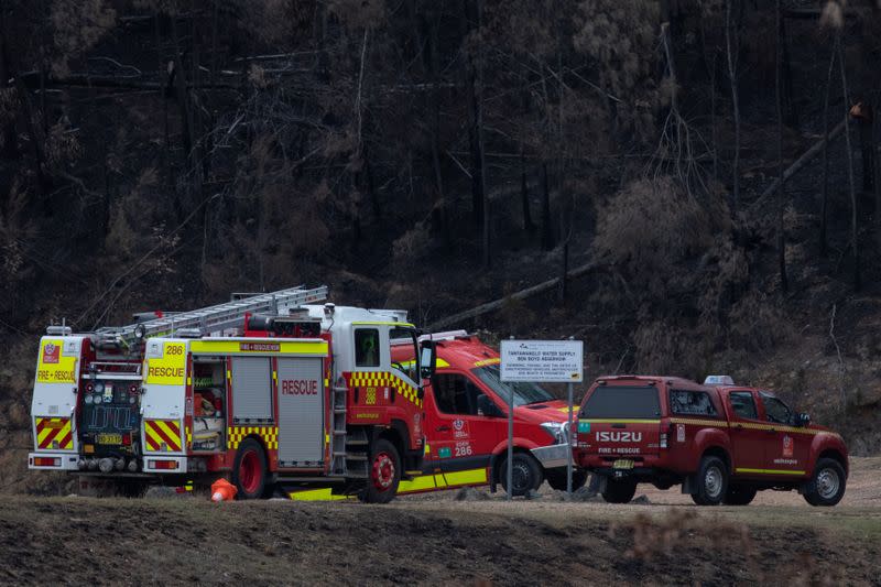 Fire rescue vehicles are seen at the Ben Boyd Reservoir following the crash of a firefighting helicopter, near Boyd Town