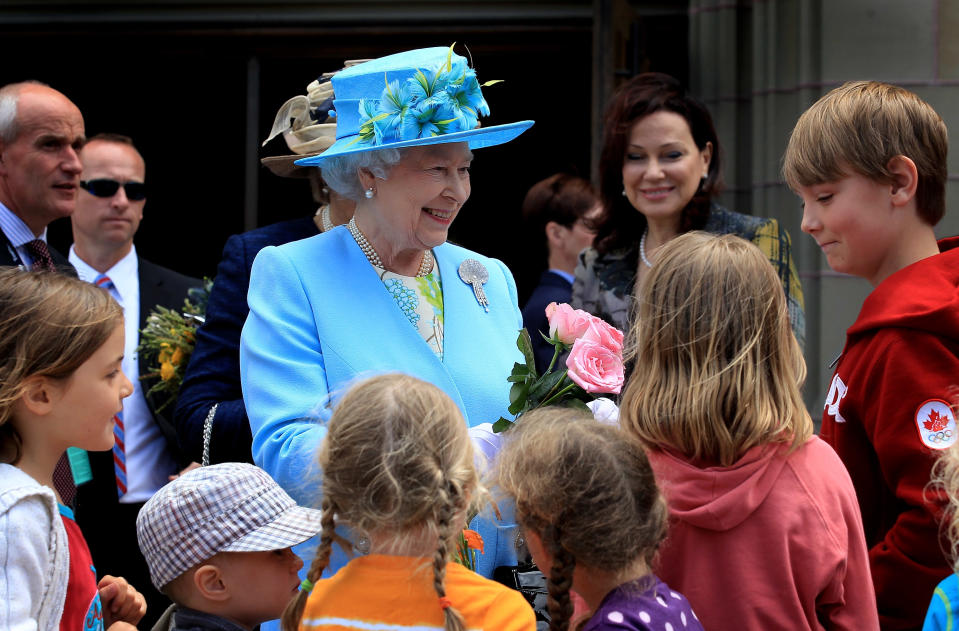 <p>While visiting Ottawa's Canadian Museum of Nature during her 2010 visit to Canada, Queen Elizabeth II was welcomed by children who gave her flowers. (Photo by Chris Jackson via Getty Images)</p> 