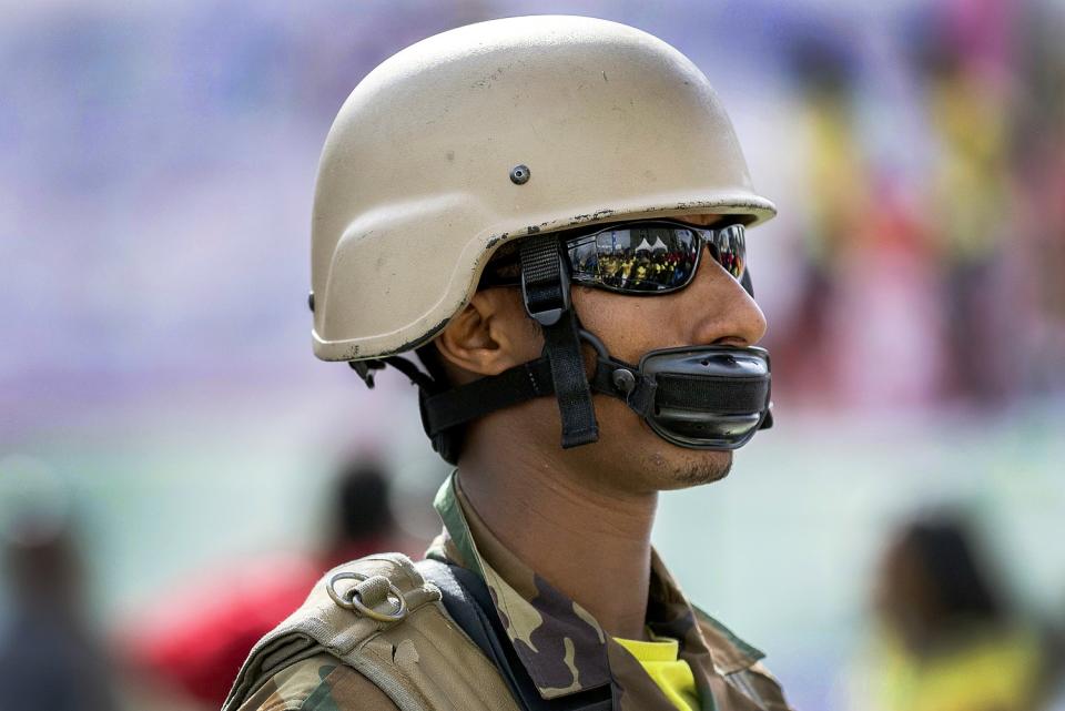 ETHIOPIA: A soldier creates a makeshift mask with his helmet's chinstrap to protect against the coronavirus in Addis Ababa.