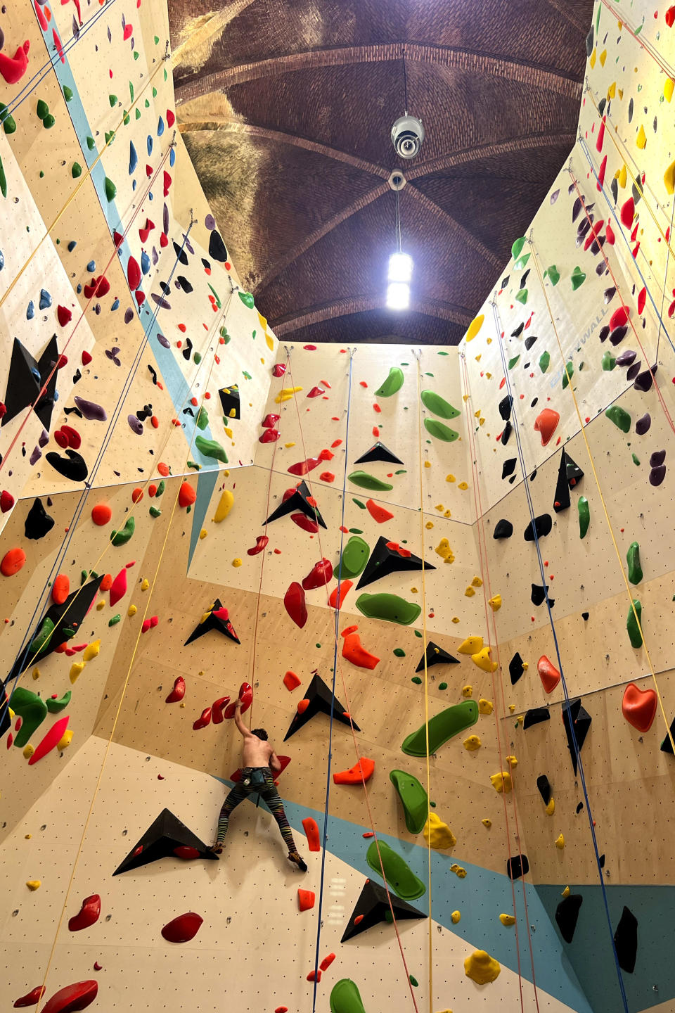 A climber scales a wall in the repurposed Saint-Antoine church in Brussels, Belgium, Wednesday, June 21, 2023. Across Europe, the continent that nurtured Christianity for most of two millennia, many churches, convents, beguinages and chapels stand empty as faith and church attendance have dwindled over the past half century. Many are now been repurposed to preserve their historical and architectural relevance, while others have opened up to non-religious activities to expand their use. (AP Photo/Sylvain Plazy)