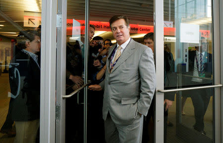 FILE PHOTO: Paul Manafort, campaign manager to Republican Presidential Candidate Donald Trump, escapes a mob of reporters asking about the Republican National Convention Committee on Rules in Cleveland, Ohio, U.S. July 14, 2016. REUTERS/Rick Wilking/File Photo