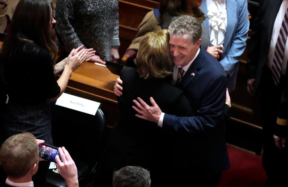Gov. Dan McKee hugs his wife, Susan, as he enters the Rhode Island House chamber for his State of the State address.