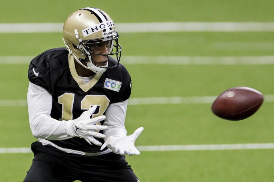 FILE - In this Saturday, Aug. 29, 2020, file photo, New Orleans Saints wide receiver Michael Thomas catches the ball during NFL football training camp in New Orleans. A person familiar with the situation says Sunday, Oct. 11, 2020, that Saints receiver Thomas has been suspended one game for conduct detrimental to the team after punching a teammate during practice. (David Grunfeld/The Advocate via AP, Pool, File)