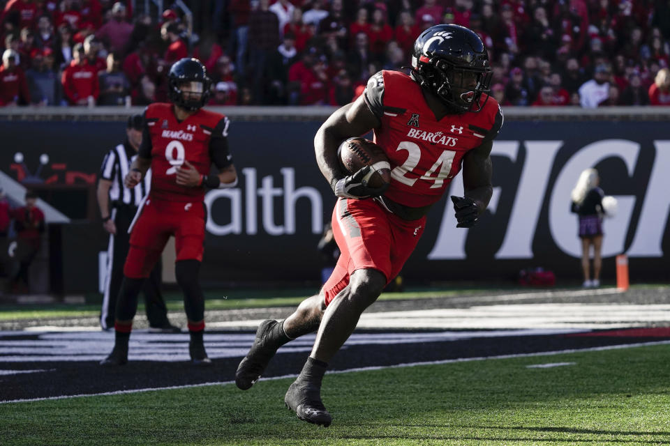Cincinnati running back Jerome Ford (24) runs with the ball during the first half of an NCAA college football game against Tulsa Saturday, Nov. 6, 2021, in Cincinnati. (AP Photo/Jeff Dean)