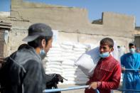 Palestinians receive food supplies at UNRWA distribution center in Gaza