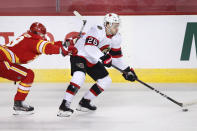 Ottawa Senators' Erik Brannstrom, right, takes a shove from Calgary Flames' Nikita Nesterov during the first period of an NHL hockey game Sunday, May 9, 2021, in Calgary, Alberta. (Larry MacDougal/The Canadian Press via AP)