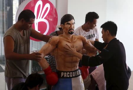 Workers from a bakery display a life-size 70-kg chocolate cake of local boxing icon Manny Pacquiao at a restaurant in Manila, Philippines May 2, 2015. REUTERS/Erik De Castro