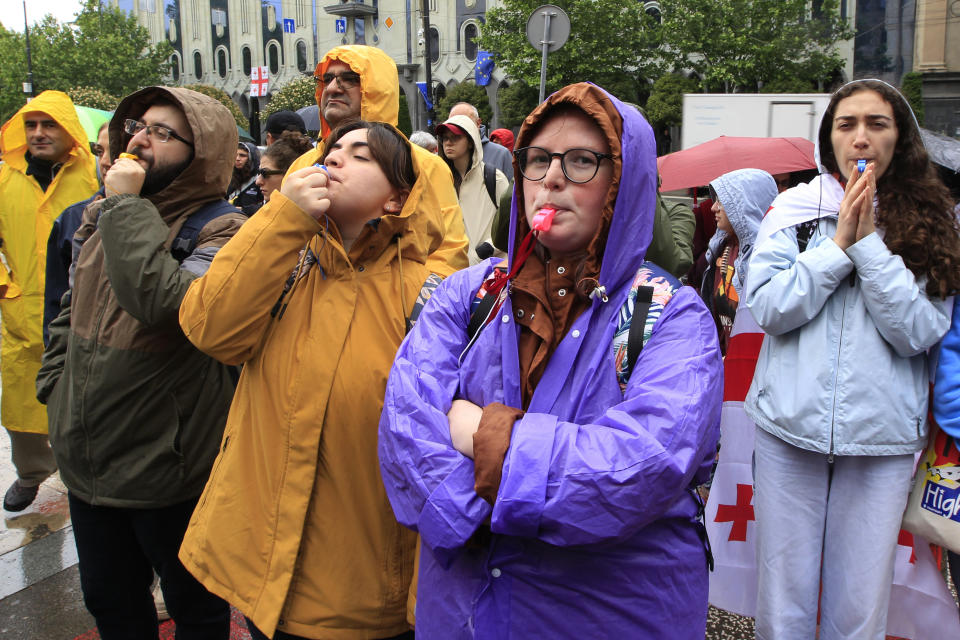 Demonstrators attend an opposition protest against "the Russian law" near the Parliament building in the center of Tbilisi, Georgia, Tuesday, May 14, 2024. Georgia's parliament on Tuesday began the third and final reading of a divisive bill that sparked weeks of mass protests, with critics seeing it as a threat to democratic freedoms and the country's aspirations to join the European Union. (AP Photo/Shakh Aivazov)