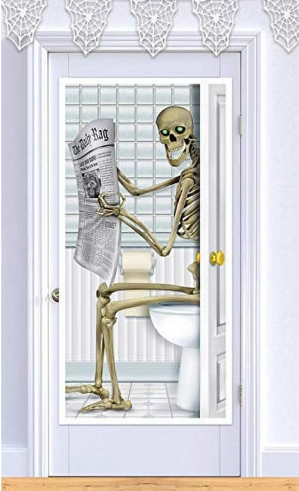 a door cover feating a skeleton on a toilet reading a newspaper