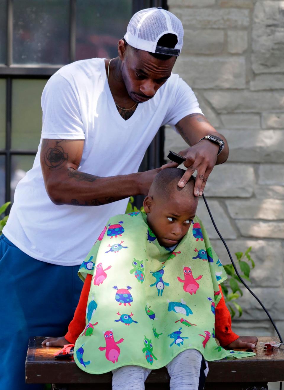 Jevon Johnson, 6, Sheboygan, gets a haircut during Juneteenth at Kiwanis Park.