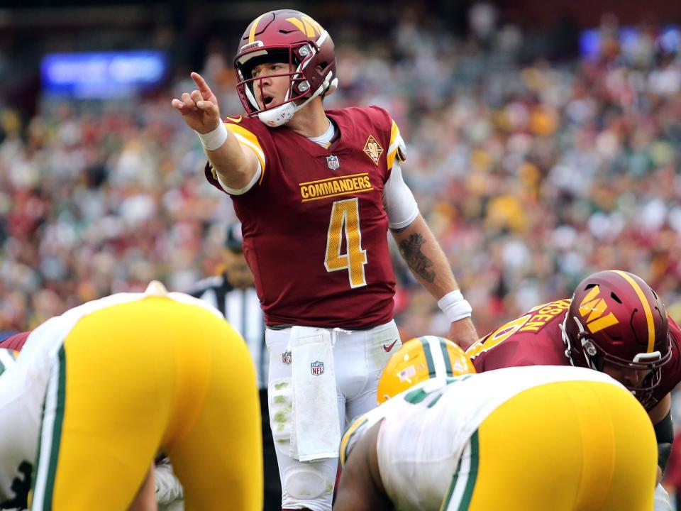 Taylor Heinicke signals before a play against the Green Bay Packers.