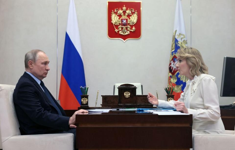 Russian President Vladimir Putin meets with Maria Lvova-Belova, Russian children's rights commissioner, at the Novo-Ogaryovo state residence, outside Moscow, on Feb. 16, 2023. The ICC issued an arrest warrant for Russian President Vladimir Putin and Lvova-Belova for coordinating the illegal transfer of children from Russian-occupied parts of Ukraine since the onset of Russia’s full-scale war. (MIKHAIL METZEL/SPUTNIK/AFP via Getty Images)