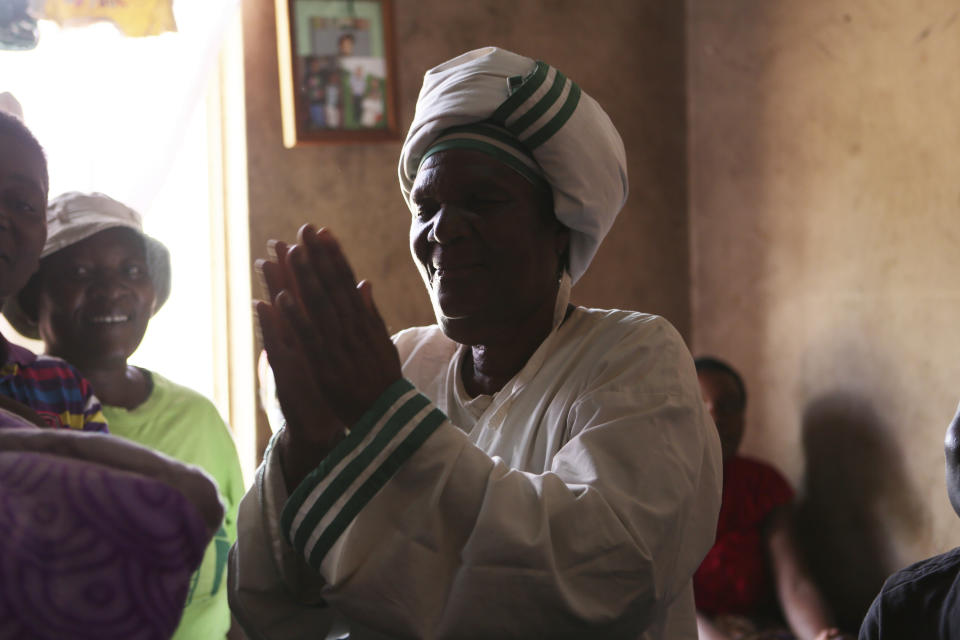 72-year old grandmother Esther Zinyoro Gwena is seen in her a tiny apartment in the poor surburb of Mbare in Harare, Zimbabwe in this Saturday, Nov. 16, 2019. Grandmother Esther Zinyoro Gwena claims to be guided by the holy spirit and has become a local hero, as the country’s economic crisis forces closure of medical facilities, and mothers-to-be seek out untrained birth attendants.(AP Photo/Tsvangirayi Mukwazhi)