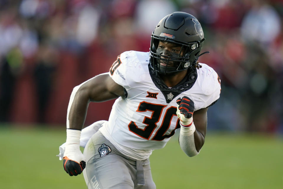 FILE - Oklahoma State defensive end Collin Oliver (30) runs on the field during the second half of an NCAA college football game against Iowa State, on Oct. 23, 2021, in Ames, Iowa. Oklahoma State opens their season at home against Central Arkansas on Sept. 2. (AP Photo/Charlie Neibergall, File)