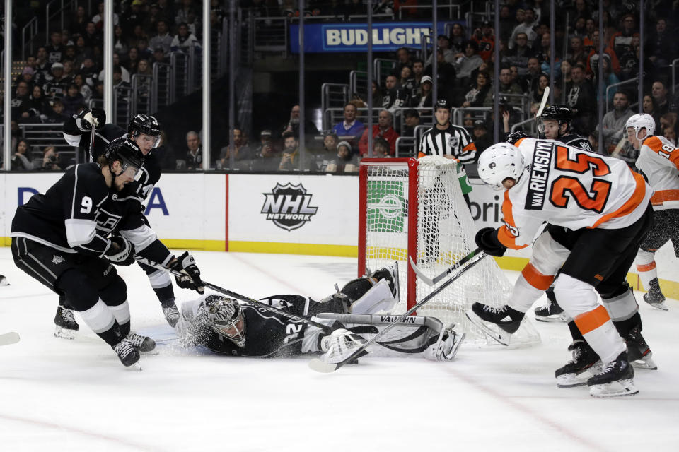 Los Angeles Kings goaltender Jonathan Quick, center, stops a shot from Philadelphia Flyers' James van Riemsdyk (25) during the third period of an NHL hockey game Tuesday, Dec. 31, 2019, in Los Angeles. (AP Photo/Marcio Jose Sanchez)