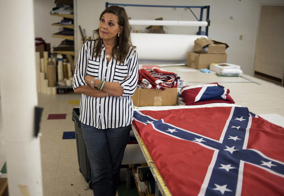 Belinda Kennedy, owner of Alabama Flag and Banner, stands by Confederate flags in the manufacturing area at her store on April 12, 2016, in Huntsville, Ala. Kennedy said the company, which sells American flags and manufactures Confederate flags, sold around 20,000 flags last year and about 12,000 of those were confederate flags. (Photo: Ty Wright/Getty Images)