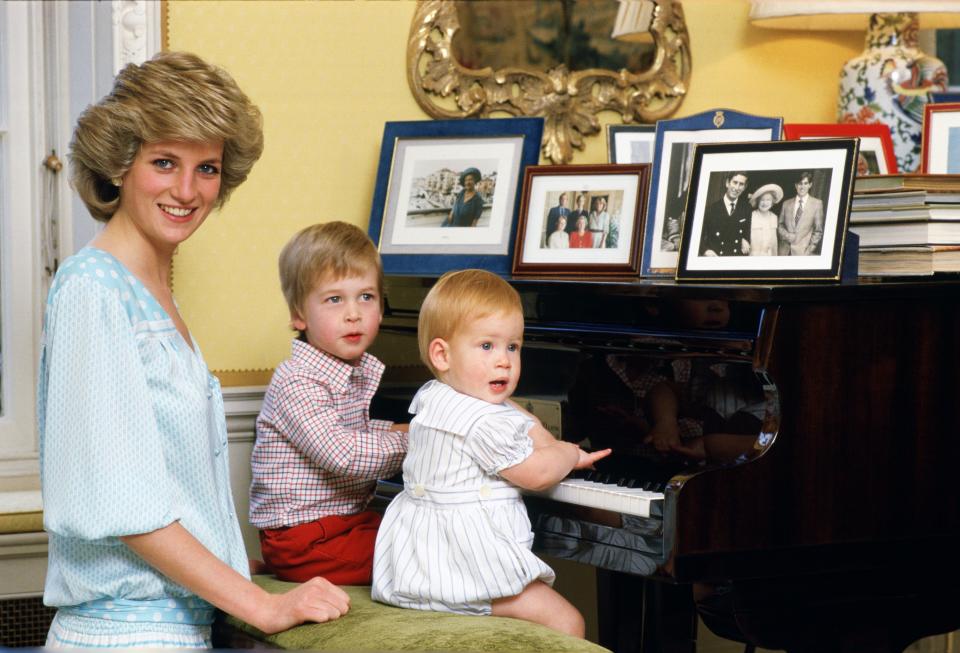 Diana, Princess of Wales with her sons, Prince William and Prince Harry sitting at the piano in Kensington Palace [Photo: Getty]