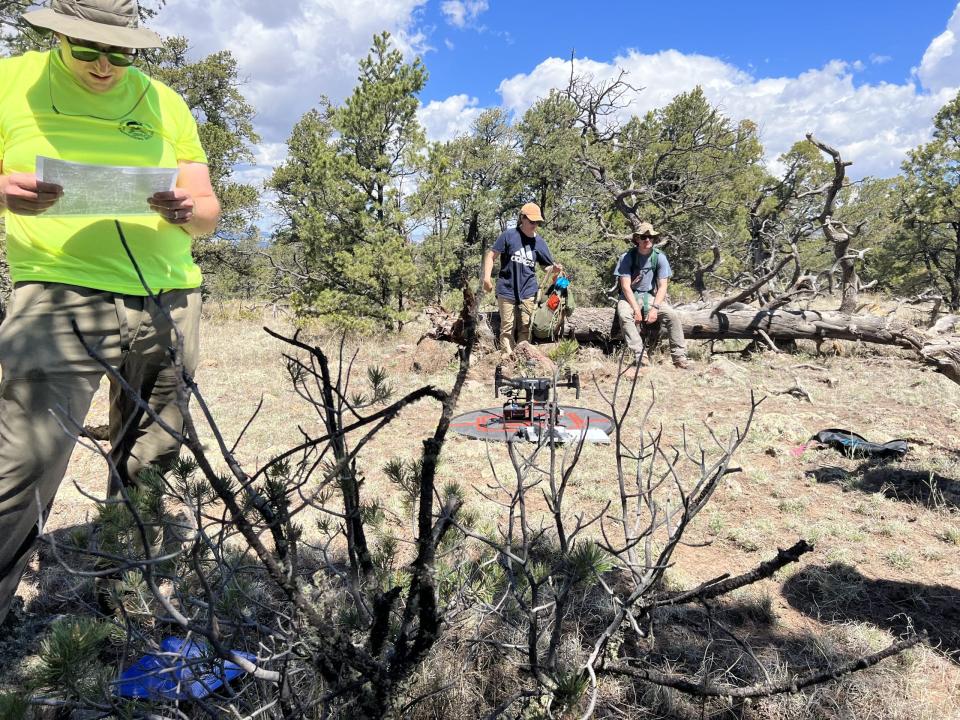 University of Missouri researchers prepare a drone equipped with lidar for a large-scale survey of a site near Lion Mountain, N.M.