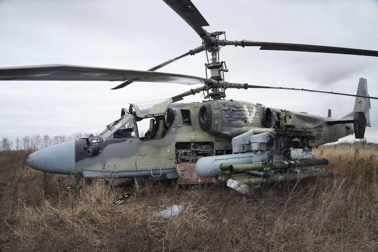 A Russian Ka-52 helicopter gunship is seen in the field after a forced landing outside Kyiv, Ukraine, Thursday, Feb. 24, 2022. Russia on Thursday unleashed a barrage of air and missile strikes on Ukrainian facilities across the country.