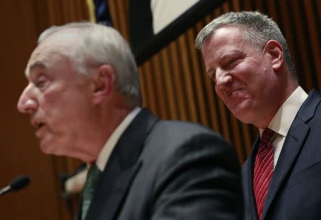 New York City Mayor Bill de Blasio smiles as New York Police Commissioner Bill Bratton speaks during a news conference in New York January 5, 2015. REUTERS/Shannon Stapleton