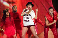 <p>At the beginning of her<i> Red</i> set, Swift recreated her iconic look from her "22" music video, in which she wears a shirt that reads "Not a lot going on at the moment" with a fedora and shorts. For the concert, she made one critical change, dropping the "not" from the T-shirt slogan. The shirt was custom by Ashish paired with Christian Louboutin loafers and a Gladys Tamez hat. </p>