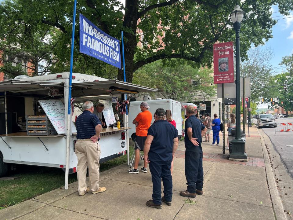 Customers wait outside the Madison Bar and Grill food truck downtown in this Eagle-Gazette file photo.