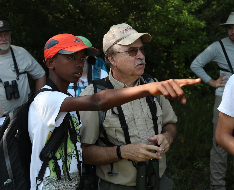 Camper Tadesse Owens points out a bird to Bob Sargent, Georgia Department of Natural Resources, during a Camp TALON visit to Harris Neck National Wildlife Refuge on Tuesday, June 6, 2023.