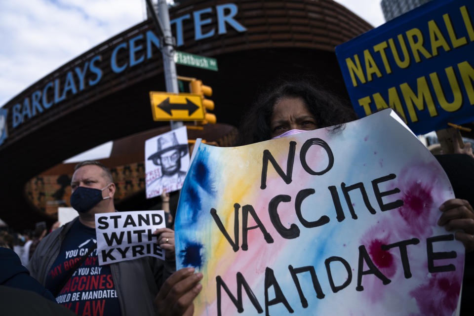 Protesters rallying against COVID-19 vaccination mandates gather in the street outside the Barclays Center before an NBA basketball game between the Brooklyn Nets and the Charlotte Hornets, Sunday, Oct. 24, 2021, in New York. (AP Photo/John Minchillo)