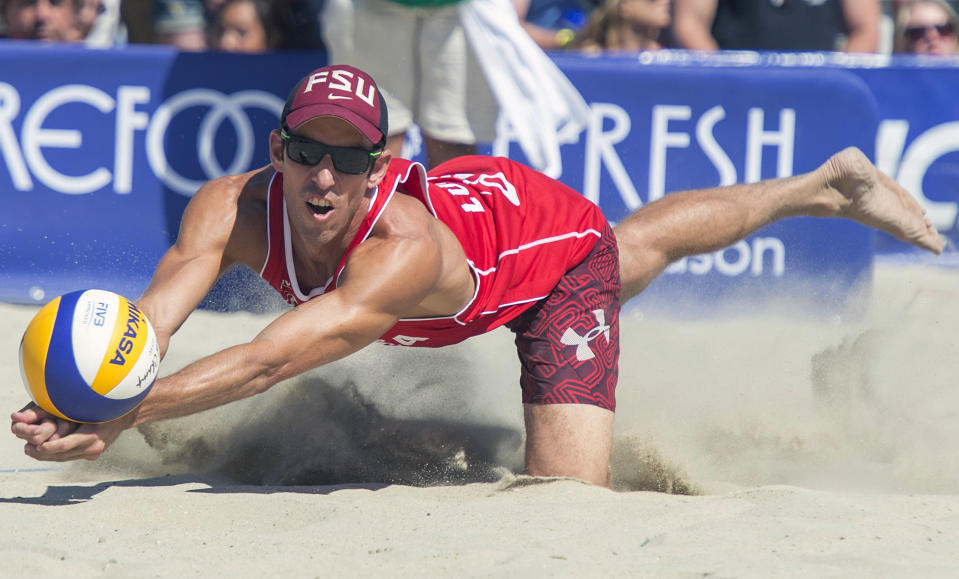 FILE - In this Aug. 23, 2015, filer photo, United States' Nick Lucena digs out a ball during the final match at the FIVB World Series of Beach Volleyball event in Long Beach, Calif. Organizers of the AVP beach volleyball tour gathered at their Orange County war room to try to salvage as much as possible of their season as the cancellations mounted in the sports world. Ideas tossed out included everything from a fan-free setup on a local beach to playing in front of a green screen in a TV studio. But with the suspension of the NBA season, it became obvious that scrapping any events before June was the only choice. (Michael Goulding/The Orange County Register via AP, File)