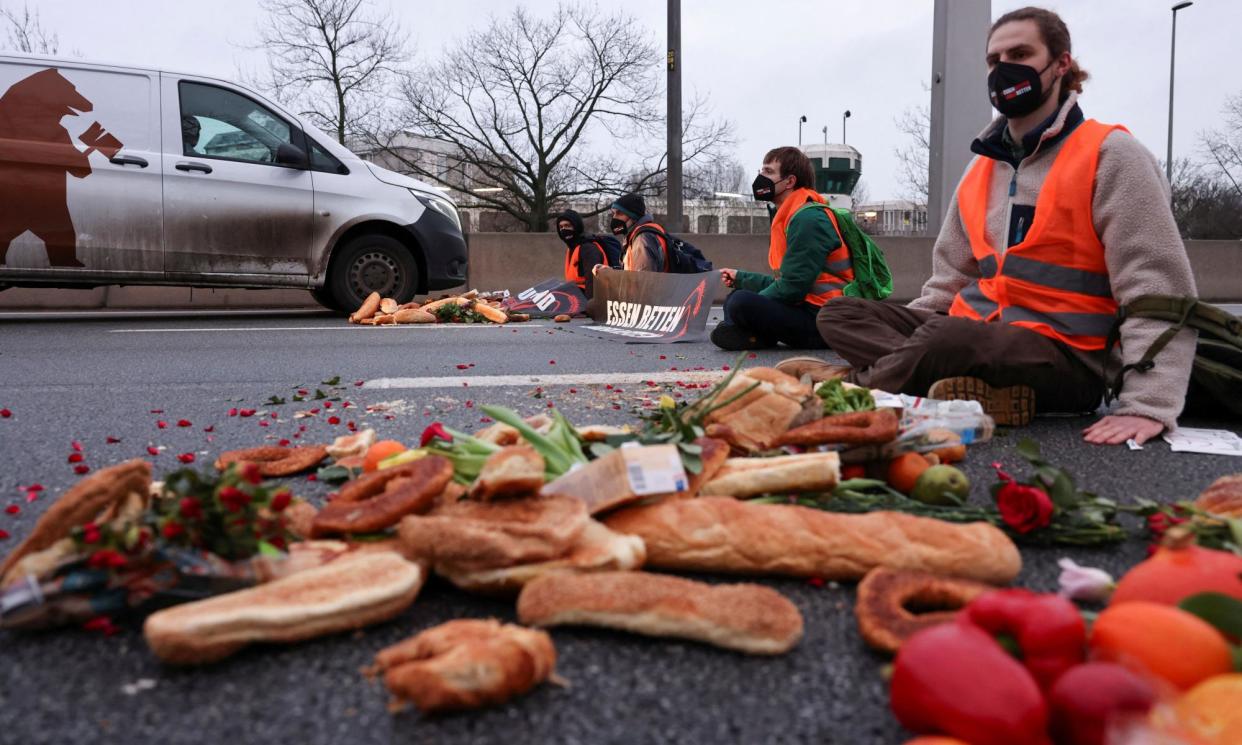 <span>Activists in Berlin, Germany, block a highway to protest against food waste and for agricultural change to reduce greenhouse gas emissions.</span><span>Photograph: Christian Mang/Reuters</span>