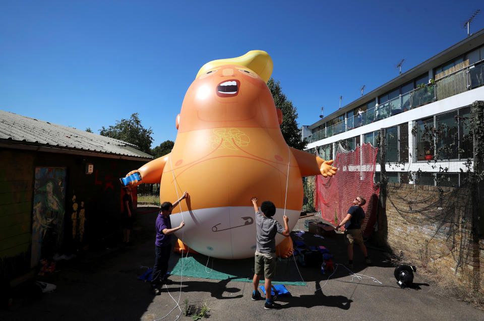 People inflate a helium filled Donald Trump blimp which they hope to deploy during The President of the United States’ upcoming visit, in London. (REUTERS/Simon Dawson)